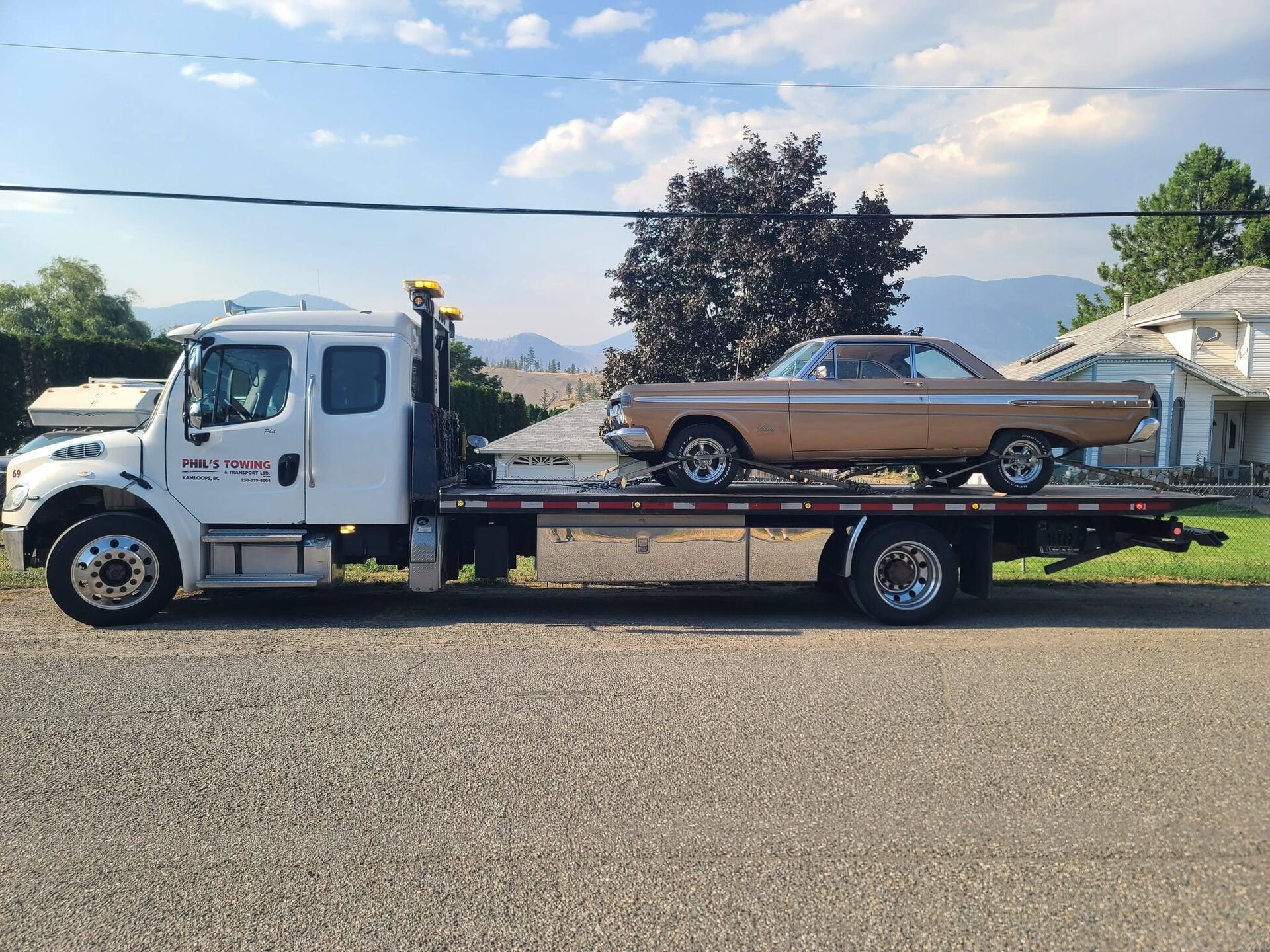 A classic muscle car loaded on Phil's Towing flat deck
