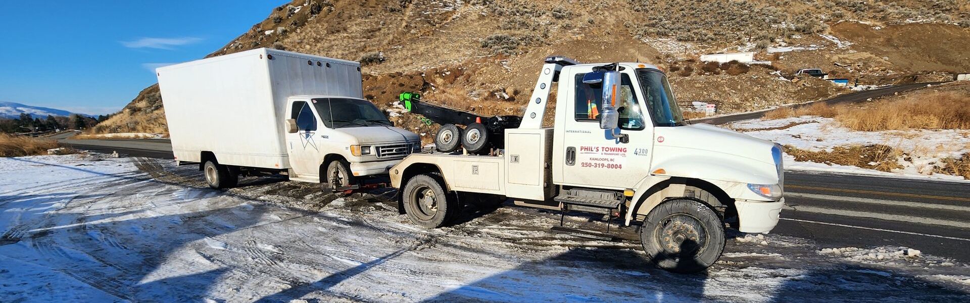 Cube van loaded onto a flatbed