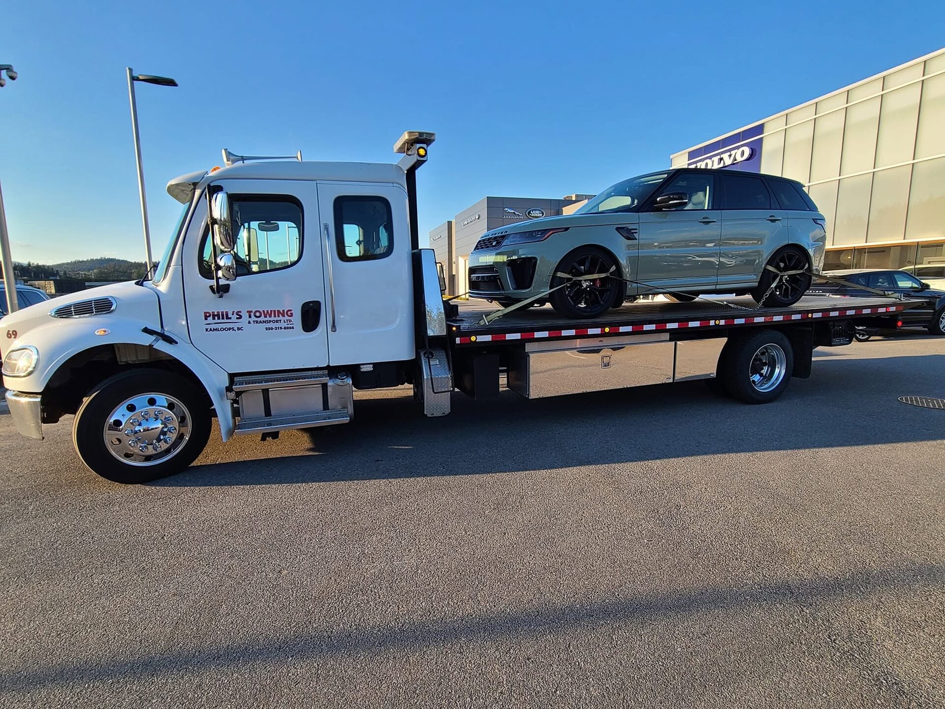 Phil's Towing delivering a vehicle to a Kelowna dealership
